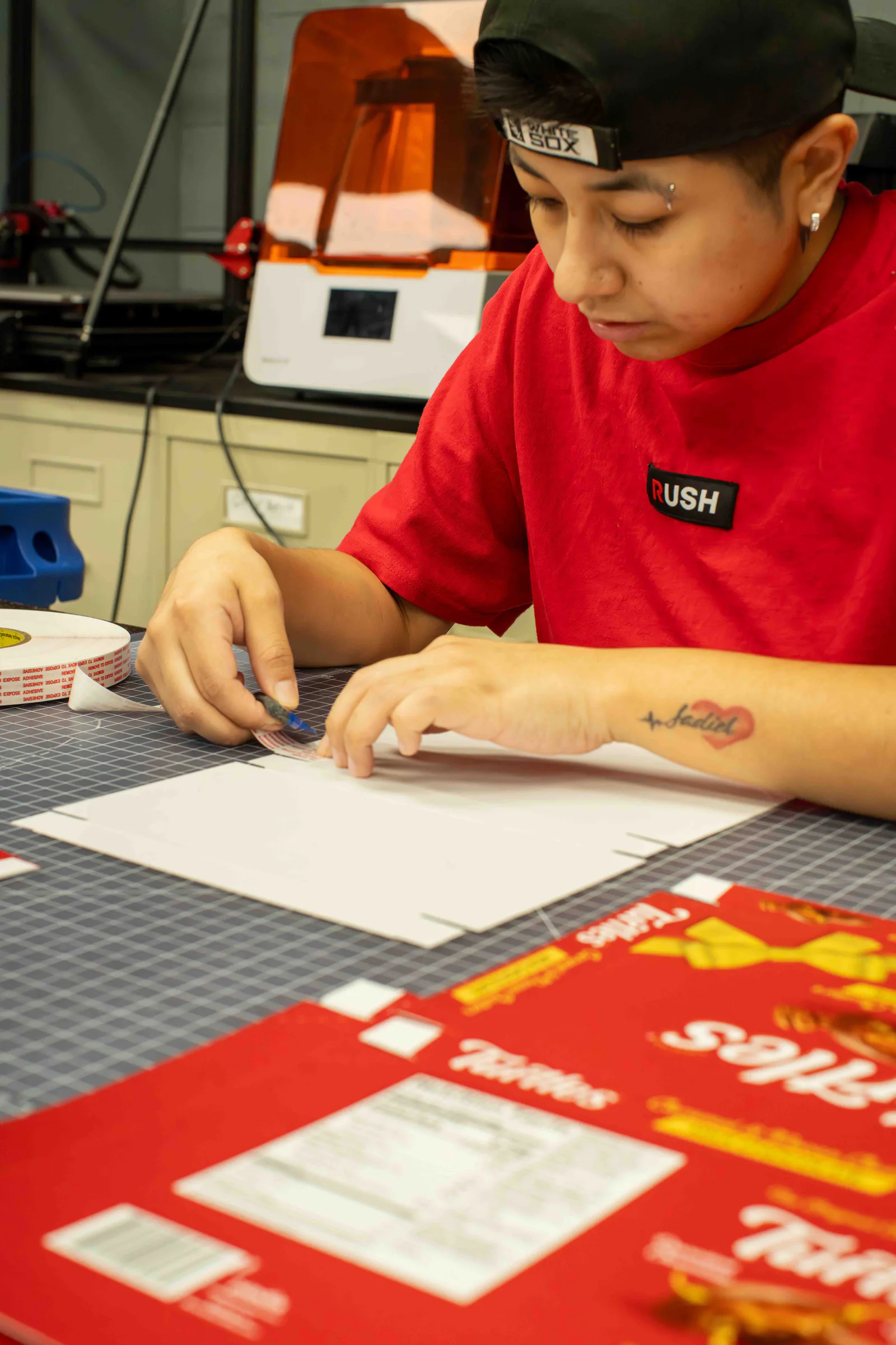 Assembling a Turtles gift box at the workbench, its printed sheets in front