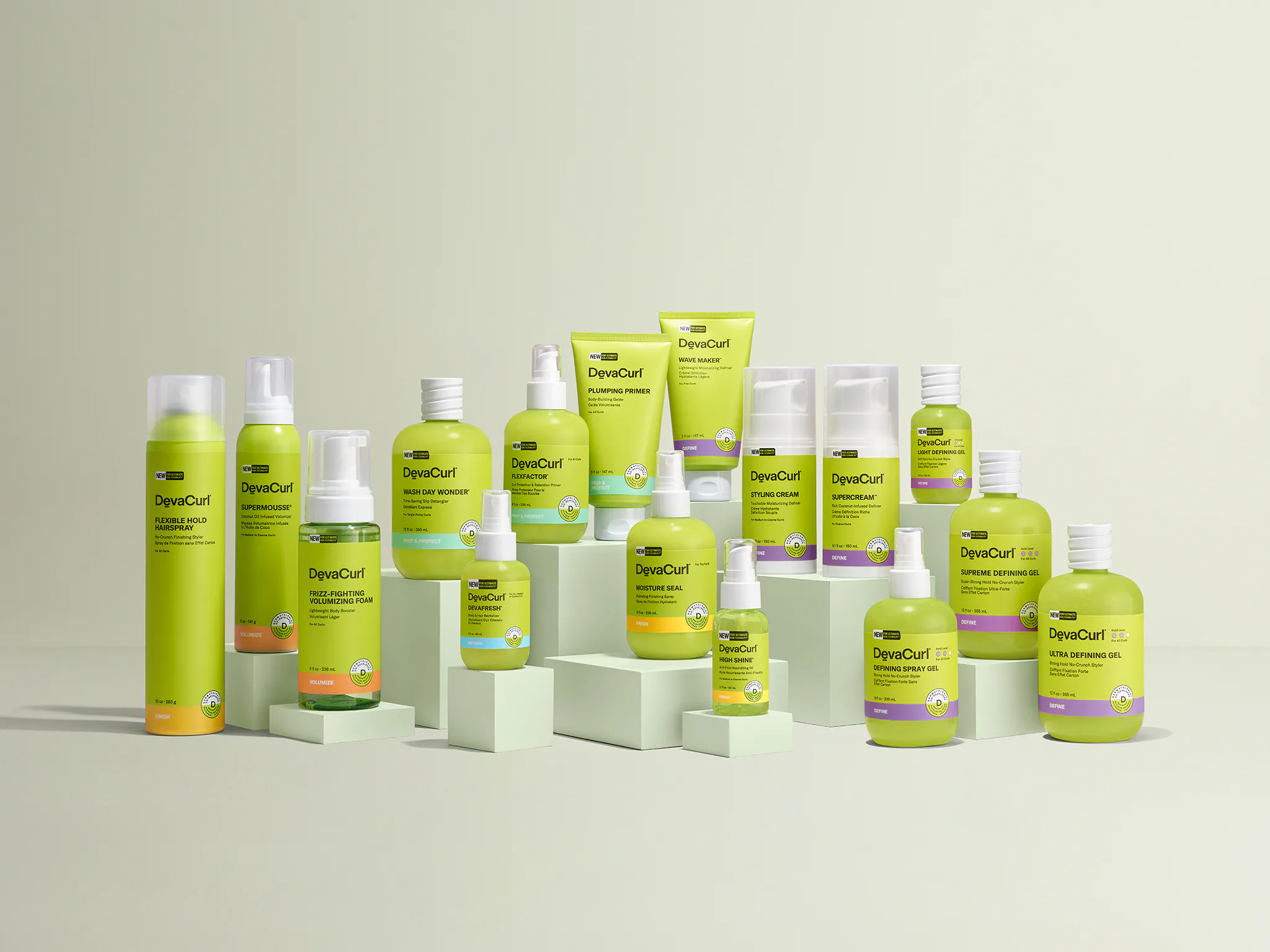The DevaCurl styling range: lime-green bottles, tubes and cans on pale green blocks