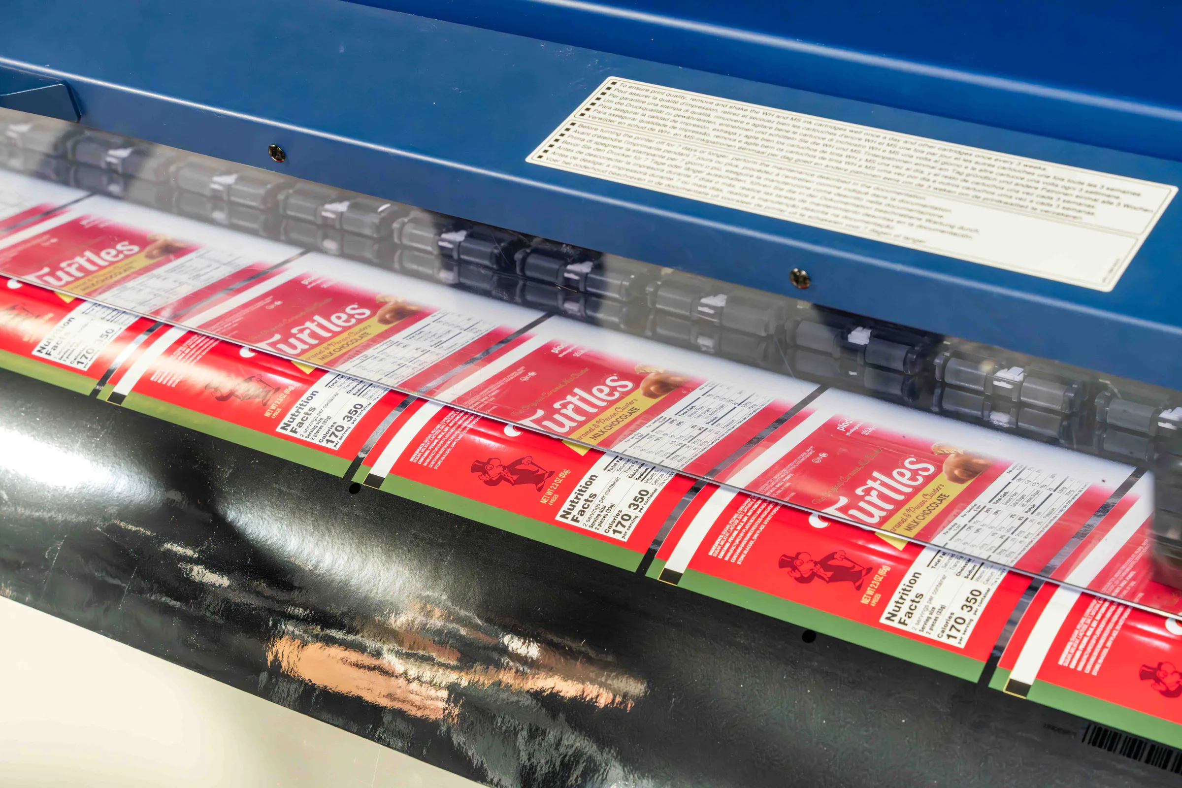 Printed sheets of Turtles boxes running through the machine, close up